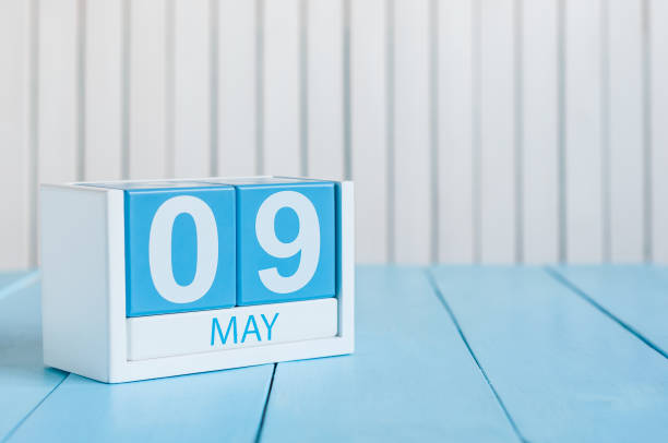 istock May 9th. Image of may 9 wooden color calendar on white background.  Spring day, empty space for text.  Symbols Of the victory in World War II 950157144