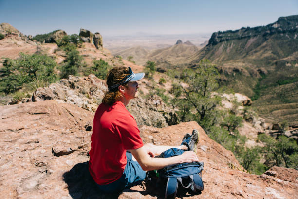 istock Man sitting and looking at the mountain view 950166886