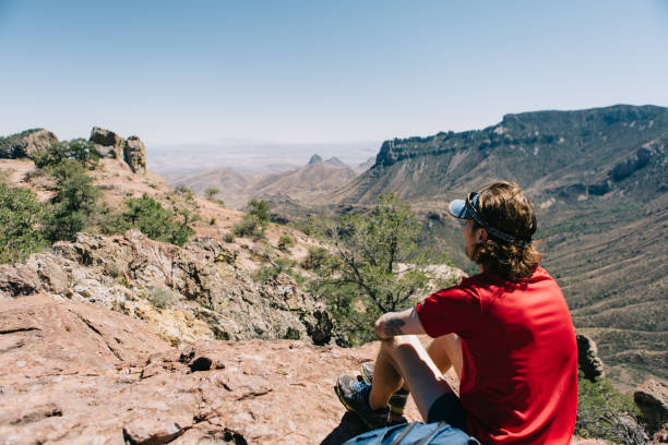 Man sitting and looking at the mountain view
