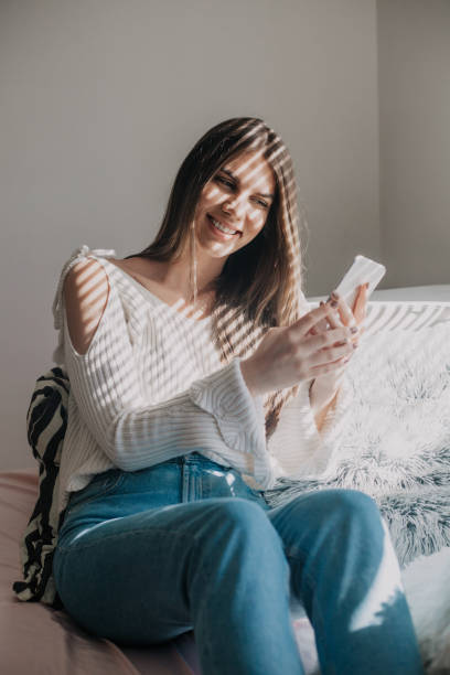 istock Young woman using phone at her home 950173126