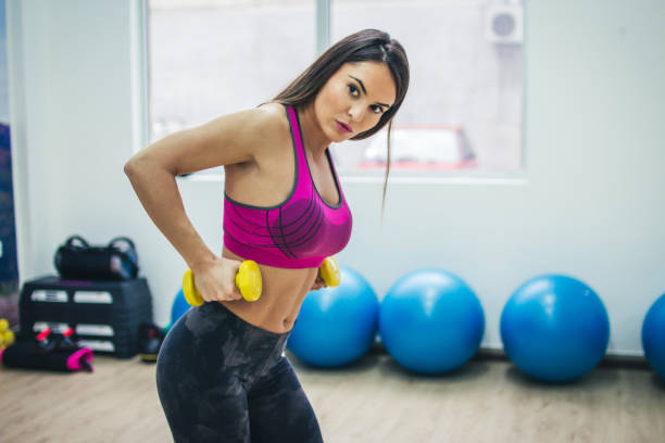 istock Woman Exercising With Dumbbells, Indoors 950176348
