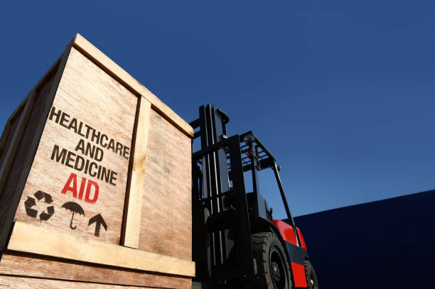 Aid cargo on forklift truck. Forklift truck with boxes on pallet. Aid cargo concept. humanitarian aid stock pictures, royalty-free photos & images
