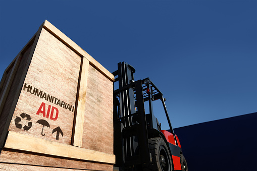 Forklift truck with boxes on pallet. Aid cargo concept.