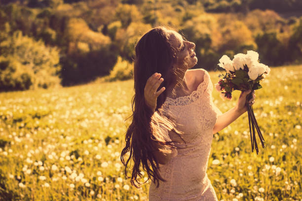 istock Bride in a Field with a Bouquet. 950179494