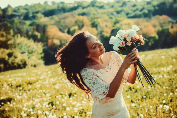 istock Bride in a Field with a Bouquet. 950179668