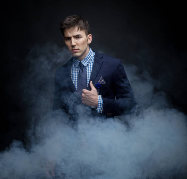 istock Well dressed businessman standing in amongst fog 950183472