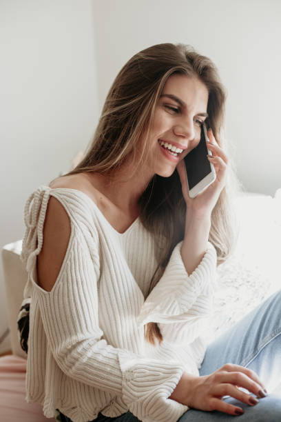 istock Young woman using phone at her home 950186886
