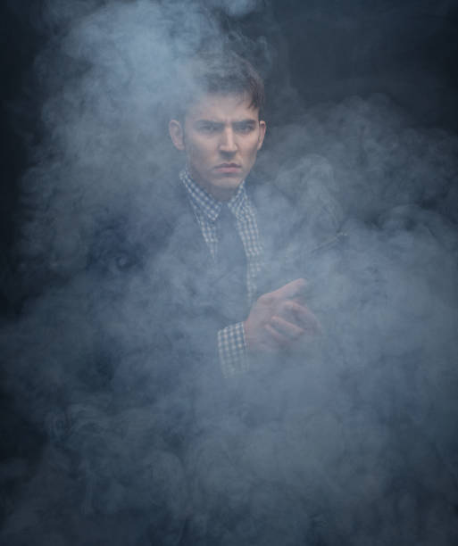 istock Well dressed businessman aiming a gun 950189360