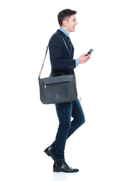 istock Handsome businessman with phone, paperwork and shoulder bag 950190522