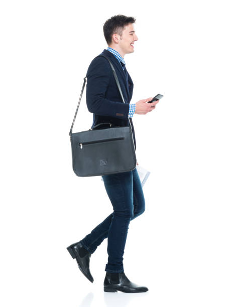 istock Handsome businessman with phone, paperwork and shoulder bag 950190544