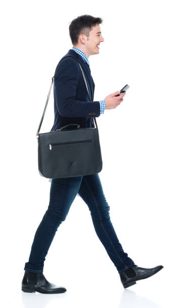 istock Handsome businessman with phone, paperwork and shoulder bag 950190548