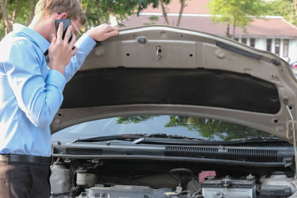 istock male agent examining engine for claiming auto insurance. caucasian man calling for assistance for car damaged by traffic accident 950196906