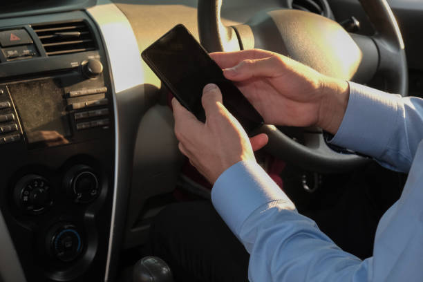 istock businessman use app on smartphone in car. man holding mobile phone checking direction before driving 950196938
