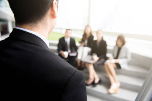 istock Businessman standing on front of his colleagues (audiences) 950201082
