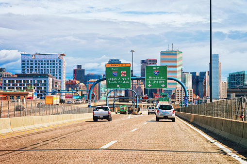 Boston, USA - April 29, 2015: Cars on the road at Boston skyline, MA, USA.