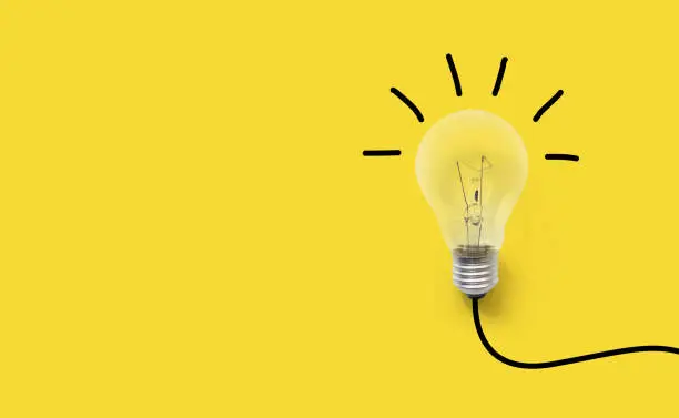 Photo of Creative thinking ideas brain innovation concept. Light bulb on yellow background