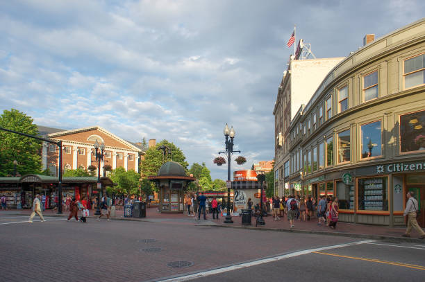 Cambridge Massachusetts Cambridge, Massachusetts, USA - 07/08/2012: This busy intersection is in Cambridge Massachusetts just up the street from Harvard Univesity you can see all the men women and young adults traveling about many visit this popular book store on this main street of this World reknown University town and visiting Harvard and Vicinity on this cloudy sky with all the beautiful colors and views made this a very special September day. cambridge massachusetts stock pictures, royalty-free photos & images