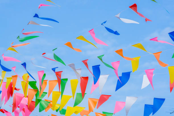 istock multi colored party rainbow flags on blue sky for celebration 950223264