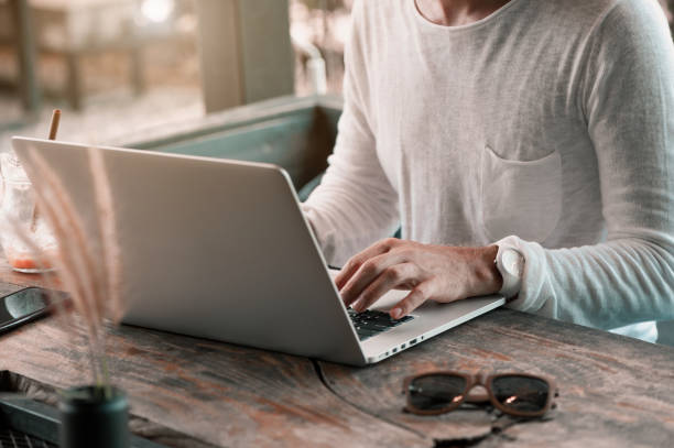 istock Young male freelancer sitting in cafe working in laptop 950223578