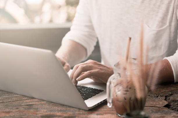 istock Young male freelancer sitting in cafe working in laptop 950223838
