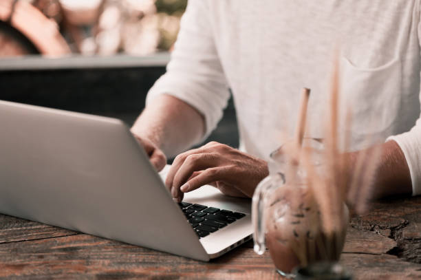 istock Young male freelancer sitting in cafe working in laptop 950223846