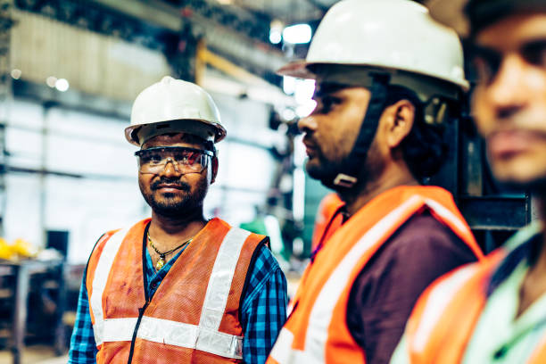 istock Group of factory employees having a conversation 950229968