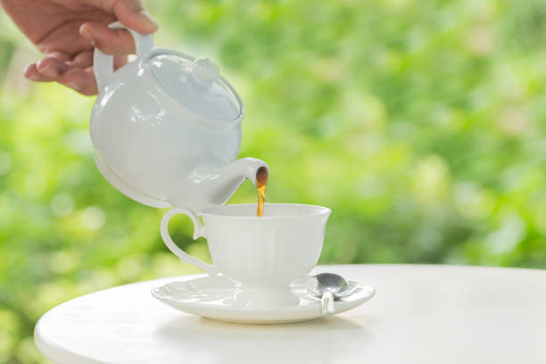 istock coffee pot pouring hot coffee into a cup during breakfast in morning sunlight 950233158