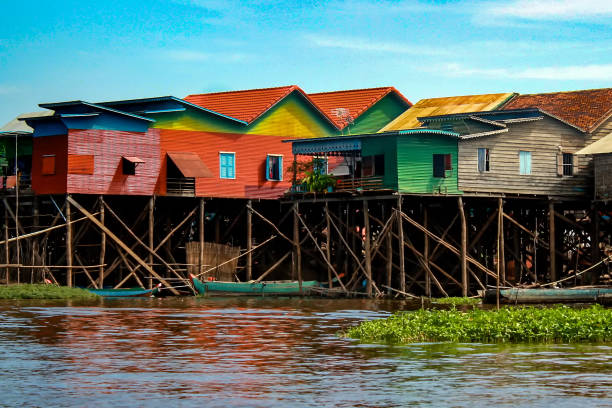Colorful, multicolored stilt houses in Lake Tonle Sap near Siem Reap in Cambodia Colorful, multicolored stilt houses line the edge of Lake Tonle Sap in the floating village of Kampong Khleang, near Siem Reap in Cambodia stilt house stock pictures, royalty-free photos & images