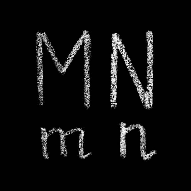 istock m, n handwritten white chalk letters isolated on black background 950236126