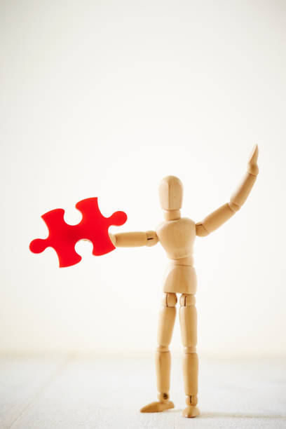 Wooden dummy Wooden dummy with jigsaw puzzle piece korean doll stock pictures, royalty-free photos & images