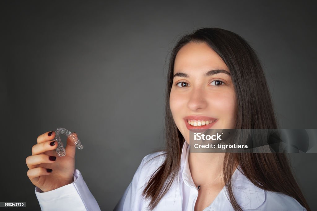 Beautiful Smiling Turkish Girl Keeping Clear Aligner On Her Hand Stock