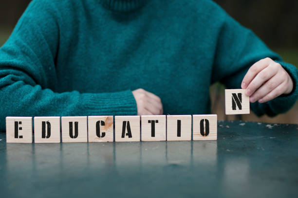 Education, Female hand playing with nine wooden blocks