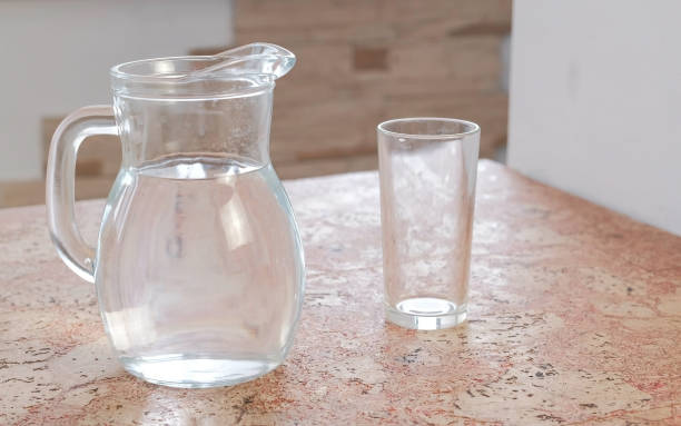 istock Decanter with water and a empty glass on the table. 950253696