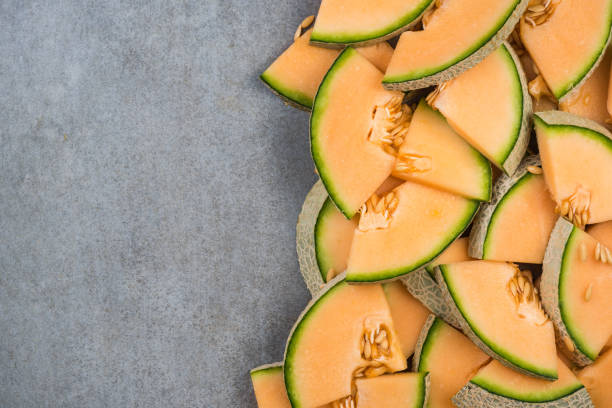 istock Cantaloupe melon slices, food border background 950253726
