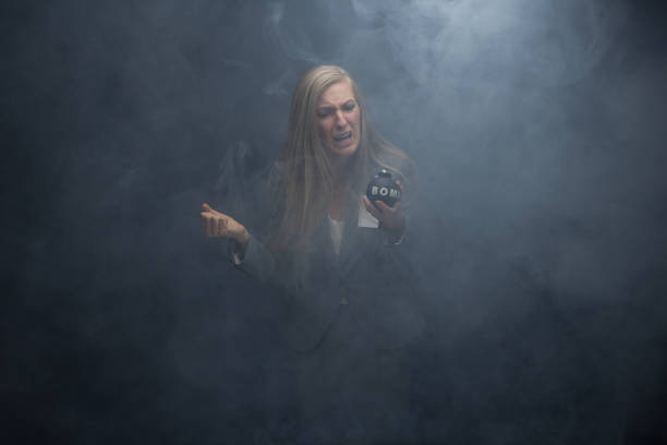 geschäftsfrau hält eine bombe - smoke one person detonator exploding stock-fotos und bilder