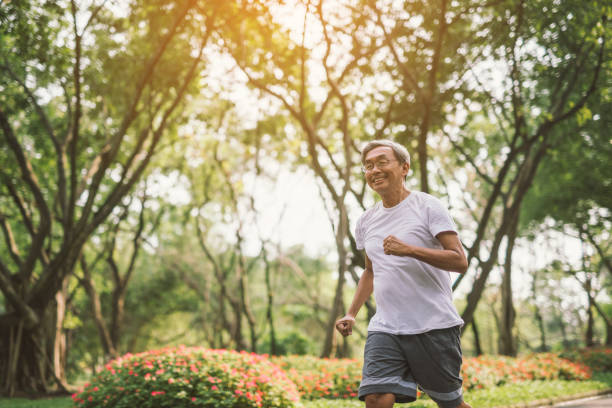 istock Asian senior mature man running Jogging In Park 950264998
