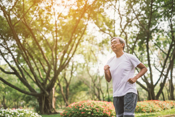 istock Asian senior mature man running Jogging In Park 950265014