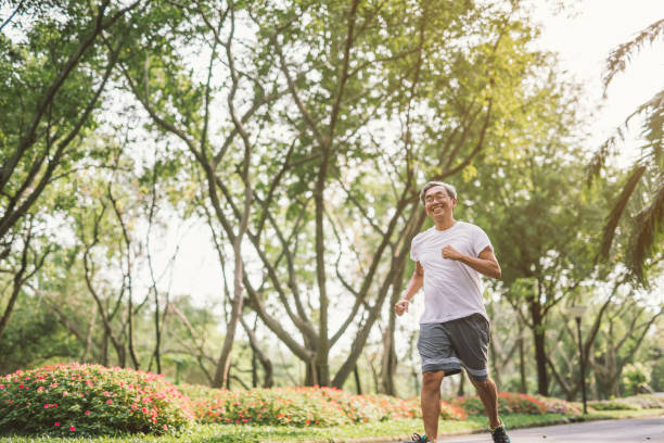 istock Asian senior mature man running Jogging In Park 950265018