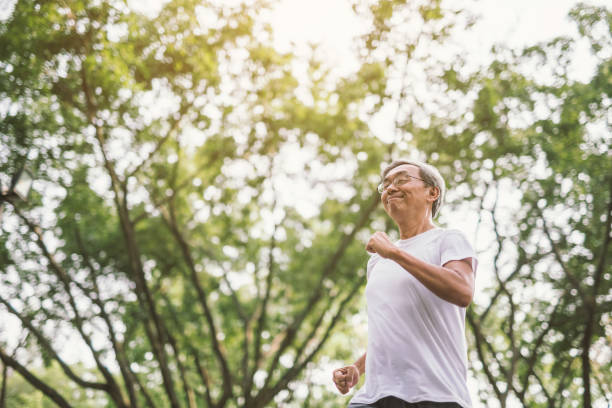 istock Asian senior mature man running Jogging In Park 950265024