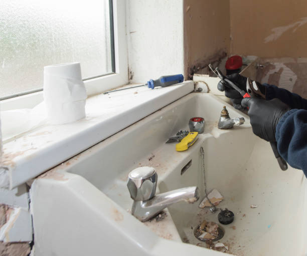 istock plumber repairing sink in desolate house 950266060