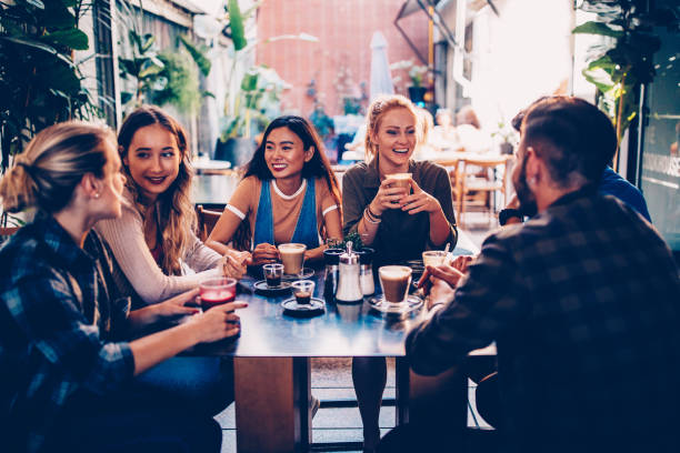 istock Multi-ethnic group of hipster friends having fun at urban cafe 950267192