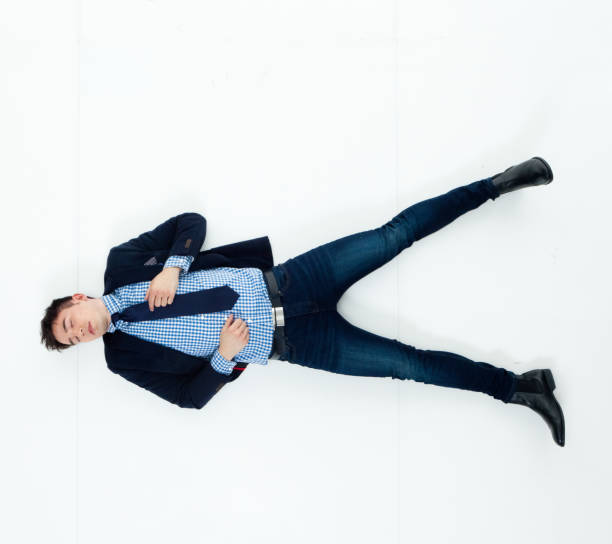 istock Handsome businessman knocked out and lying on floor 950271034