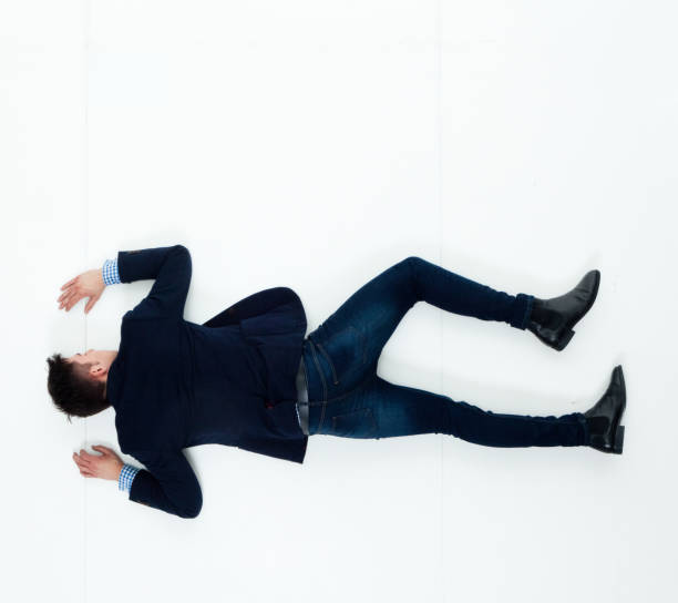 istock Handsome businessman knocked out and lying on floor 950271070