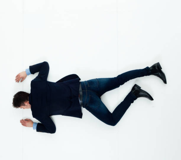 istock Handsome businessman knocked out and lying on floor 950271082