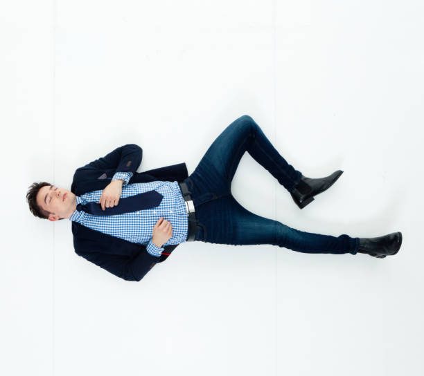istock Handsome businessman knocked out and lying on floor 950271090