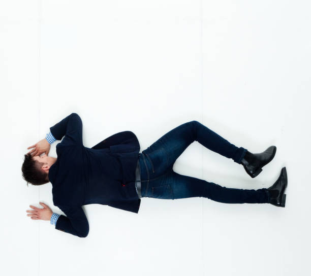 istock Handsome businessman knocked out and lying on floor 950271124