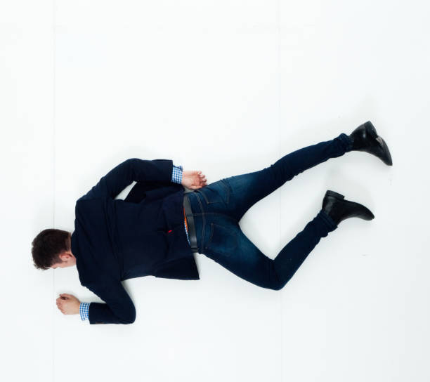 istock Handsome businessman knocked out and lying on floor 950271132