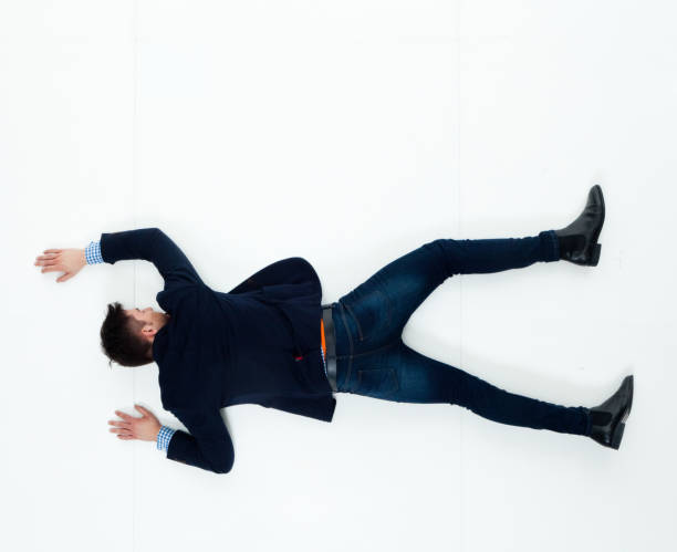 istock Handsome businessman knocked out and lying on floor 950271168
