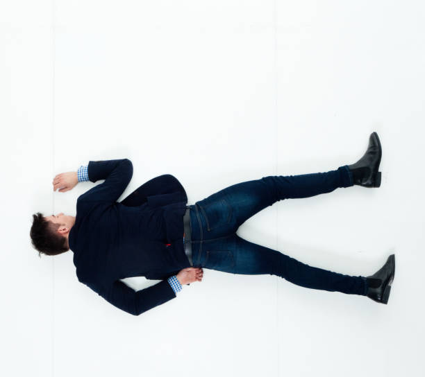 istock Handsome businessman knocked out and lying on floor 950271174