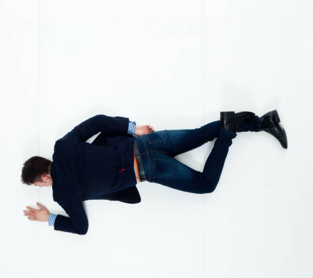 istock Handsome businessman knocked out and lying on floor 950271212